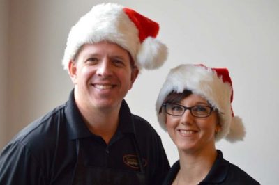 Brent and Jacqueline wearing Santa hats